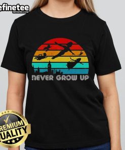 Vintage ladies tee featuring an original Peter Pan silhouette with 'Never Grow Up' text, perfect for whimsical fashion lovers.