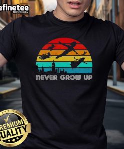 Vintage Peter Pan silhouette T-shirt featuring 'Never Grow Up' design, perfect for fans of classic children's stories.