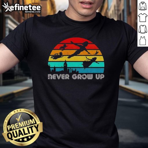 Vintage Peter Pan silhouette T-shirt featuring 'Never Grow Up' design, perfect for fans of classic children's stories.