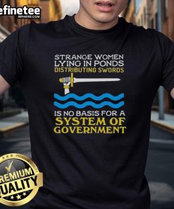 Original Strange Women Lying In Ponds Distributing Swords T-Shirt featuring whimsical artwork and humorous political satire.