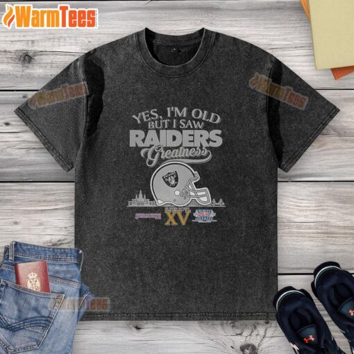 Alt Text: Vintage Oakland Raiders Super Bowl helmet graphic on a washed t-shirt with city skyline, perfect for fans.