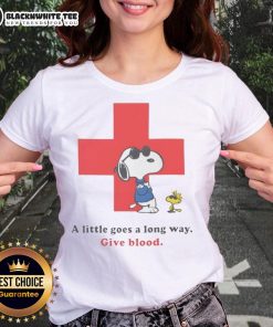 Premium American Red Cross Peanuts Snoopy tee for ladies promoting blood donation with 'A Little Goes A Long Way' slogan.