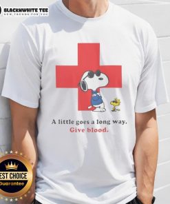 Alt Text: Premium American Red Cross Peanuts Snoopy t-shirt promoting blood donation with A Little Goes A Long Way slogan.
