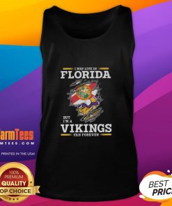 Premium tank top featuring 'I May Live In Florida But I'm A Minnesota Vikings Fan Forever' design, perfect for fans.