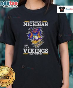 Premium ladies tee featuring 'I May Live In Michigan But I'm A Minnesota Vikings Fan Forever' design.