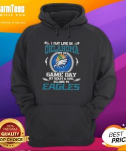 Premium hoodie with 'I May Live In Oklahoma But My Heart Belongs To Philadelphia Eagles' design for fans.