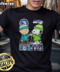 Alt Text: Premium Snoopy and Charlie Brown Seattle City sports T-shirt featuring Mariners and Seahawks skyline design.