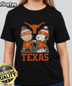 Premium Snoopy and Charlie Brown Texas Longhorns football skyline ladies tee featuring vibrant graphics and soft fabric.