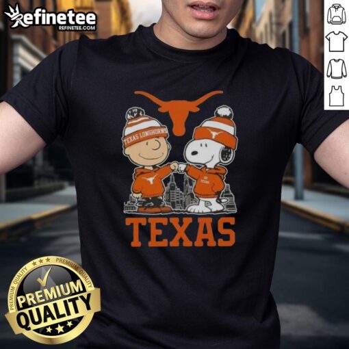 Alt Text: Premium Snoopy and Charlie Brown Texas Longhorns football skyline t-shirt featuring iconic characters in vibrant colors.