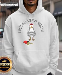 Pretty emotional support seagull in a hoodie enjoying french fries at the beach, showcasing a fun and quirky moment.