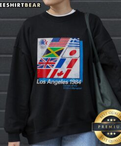 Alt Text: Vintage 'Pretty Los Angeles 1984 Games of the XXIIIrd Olympiad' sweatshirt featuring colorful Olympic flags.