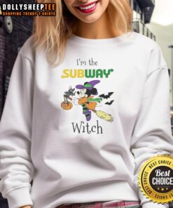 Pretty Minnie Mouse in a witch costume on a subway, celebrating Halloween in a Trick or Treat sweatshirt.