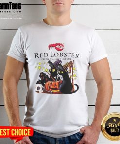 Pretty red lobster wearing a witch hat, surrounded by pumpkins at a haunted house on a Halloween T-shirt.