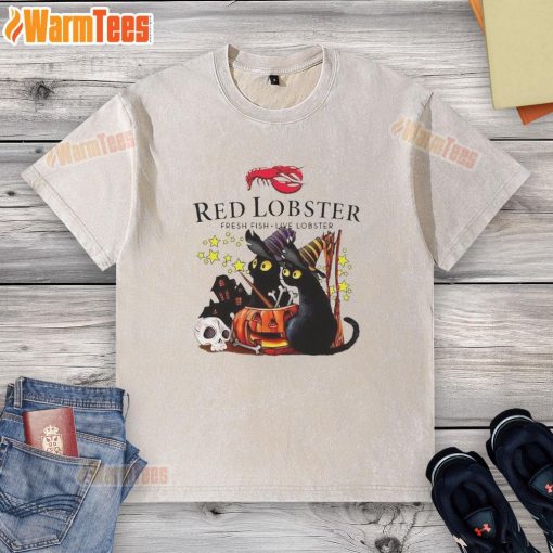 Pretty red lobster design on a black cat witch pumpkin Halloween washed t-shirt, perfect for festive celebrations.