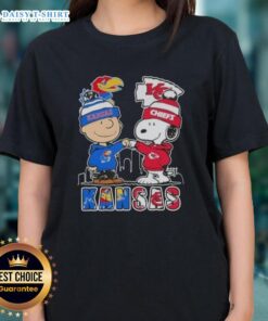 Pretty Snoopy and Charlie Brown Kansas City Sports tee featuring Jayhawks and Chiefs skyline design for ladies.