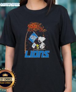 Pretty Snoopy and Woodstock celebrate the holidays on a Detroit Lions ladies tee, perfect for festive football fans.