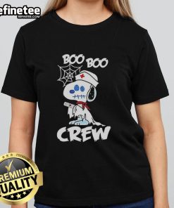 Alt Text: Pretty Snoopy Halloween cartoon tee featuring a nurse ghost from Peanuts x Boo Boo Crew for ladies.