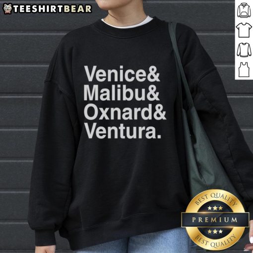 Cozy 'Pretty Venice Malibu Oxnard and Ventura' sweatshirt displayed on a wooden background, perfect for casual wear.