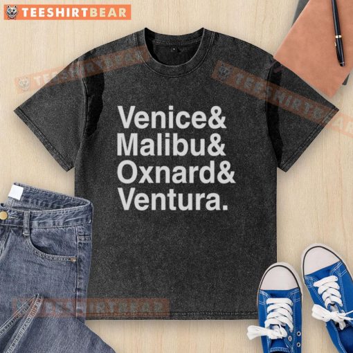 Pretty Venice Malibu Oxnard and Ventura washed t-shirt displayed on a rustic wooden background, perfect for casual wear.