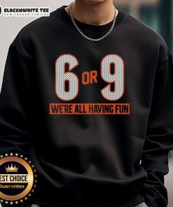 Group of friends wearing 'Top-6-Or-9-Were-All-Having-Fun' sweatshirts, enjoying a fun outdoor gathering.