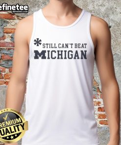 Top Asterisk Still Can't Beat Michigan Wolverines Tank Top featuring bold graphics and team colors for fans.