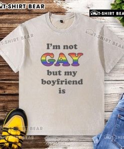 Top I'm Not Gay But My Boyfriend Is T-Shirt, featuring a humorous slogan in bold letters on a casual tee.