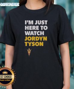 Alt Text: Top featuring Jordyn Tyson's 'Im Just Here To Watch' graphic design on a ladies tee, perfect for casual wear.