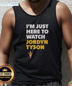 Alt Text: Jordyn Tyson wearing a stylish 'I'm Just Here to Watch' tank top, showcasing a trendy summer outfit.