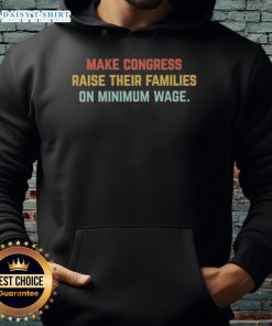 Person wearing a hoodie with 'Top Make Congress Raise Their Families on Minimum Wage' slogan, advocating for fair wages.