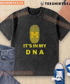 Top Michigan It's In My DNA washed t-shirt displayed on a wooden surface, showcasing a casual and stylish design.