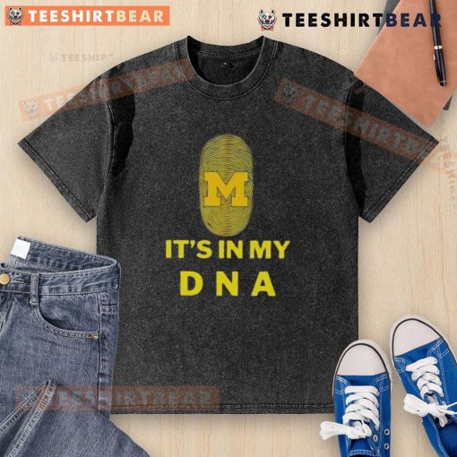 Top Michigan It's In My DNA washed t-shirt displayed on a wooden surface, showcasing a casual and stylish design.