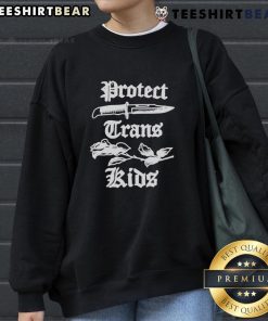 Peggy Flanagan wearing a 'Protect Trans Kids' sweatshirt, advocating for LGBTQ+ rights in Minnesota.