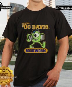 Alt Text: Top Monster Disney UC Davis Bookworm T-Shirt featuring a colorful graphic of a cute monster reading a book.