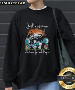 Woman wearing a cozy sweatshirt with 'Just a Woman Who Loves Fall and Philadelphia Eagles Football' design.