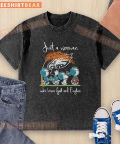 Just a woman who loves fall and Philadelphia Eagles football in a washed t-shirt featuring peanuts design.