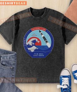 Top Rocket Lab 'The Sea God Sees Outer Space' mission patch on a washed t-shirt, featuring a vibrant space design.