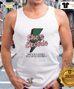 Model wearing 'Top She's Electric' tank top in a quirky family setting, showcasing unique style and personality.