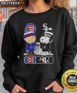 Alt Text: Top Snoopy and Charlie Brown Chicago City Sports Cubs X White Sox Skyline Sweatshirt featuring iconic characters.