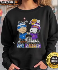 Top Snoopy and Charlie Brown Los Angeles Sports Dodgers x Lakers skyline sweatshirt featuring iconic cartoon characters.