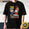 Alt Text: Top Snoopy and Charlie Brown Michigan Sports Wolverines x Detroit Tigers skyline T-shirt design featuring iconic characters.