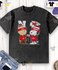 Top Snoopy and Charlie Brown Nebraska Huskers x Kansas City Chiefs skyline washed t-shirt design featuring iconic characters.