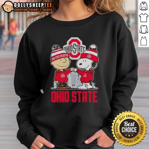 Alt Text: Cozy Ohio State Buckeyes football sweatshirt featuring Snoopy and Charlie Brown against a city skyline backdrop.