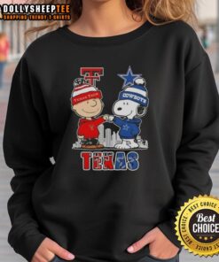 Alt Text: Cozy sweatshirt featuring Snoopy and Charlie Brown with Texas Tech Red Raiders and Dallas Cowboys skyline design.
