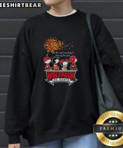 Cozy autumn sweatshirt featuring Snoopy and friends with NC State sports team design, perfect for fall festivities.