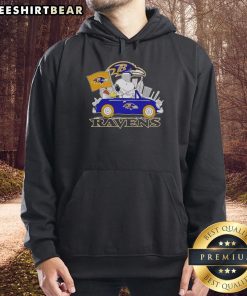 Snoopy and Woodstock driving a car with Baltimore Ravens city skyline on a cozy hoodie, perfect for fans.