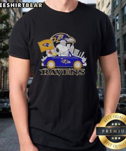 Snoopy and Woodstock driving a car with Baltimore Ravens city skyline on a T-shirt, perfect for football fans.