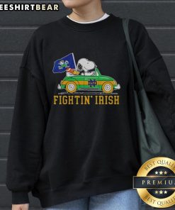 Top Snoopy and Woodstock driving a car on a Notre Dame Fighting Irish sweatshirt, perfect for fans and cozy wear.