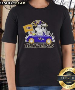 Snoopy driving a car in a Baltimore Ravens football ladies tee, perfect for fans and casual wear.