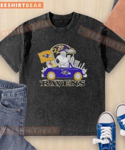 Alt Text: Snoopy driving a car in a Baltimore Ravens football washed t-shirt, showcasing team spirit and fun style.