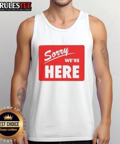 Model wearing a stylish Top Sorry We're Here Tank Top in a vibrant outdoor setting, showcasing trendy summer fashion.